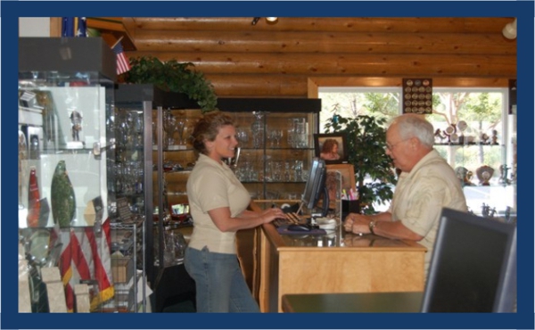 Kami, from Arnolds for Awards in Shingle Springs, California assists a customers at the counter using BizWizard Order Manager&trade;